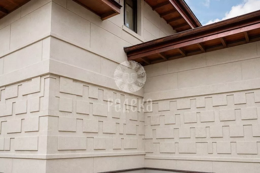 Geometric ornament on adjacent walls of the stone facade under the roof overhangs.