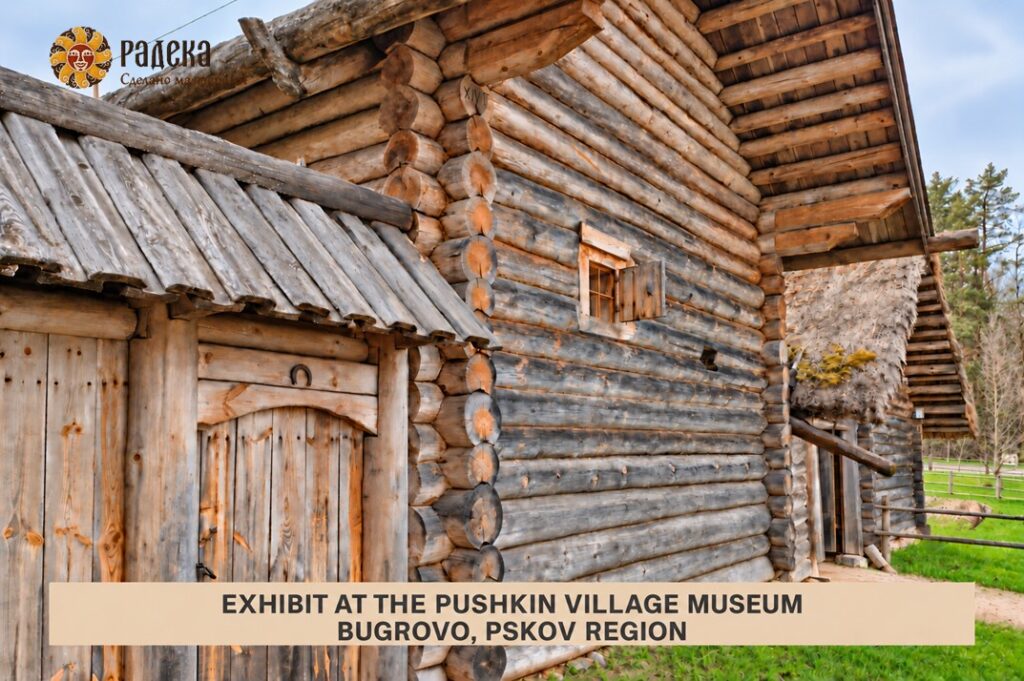 Board-covered roof with a wide overhang above wooden gates at the Pushkin Village Museum in Bugrovo.