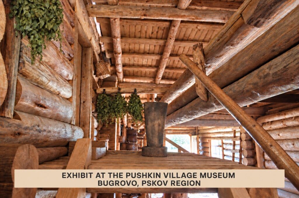 View from beneath a wooden roof at the Pushkin Village Museum in Bugrovo, showing roofing boards and supporting timbers.