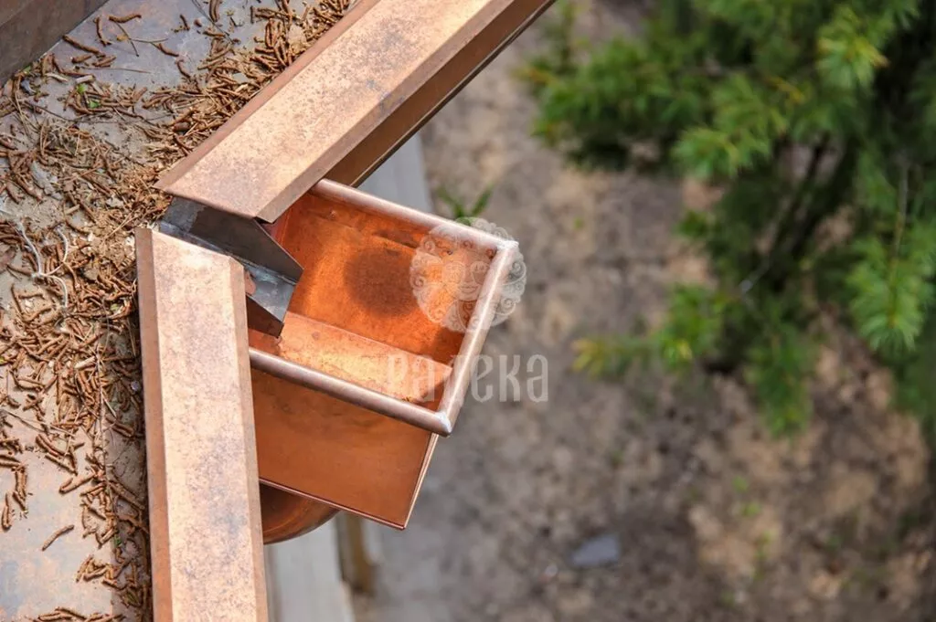 Close-up view from above of a rectangular copper hopper head