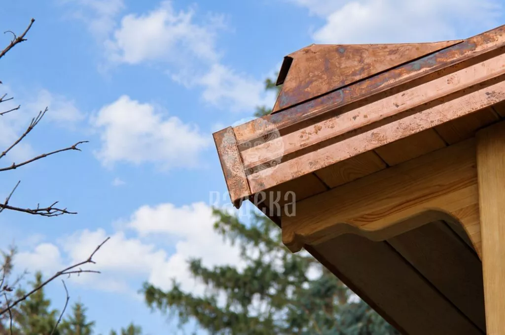 Profiled copper trim along the gable edge of a timber canopy