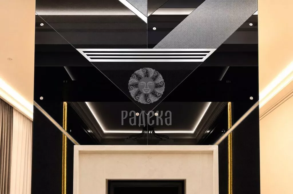 Geometric cladding of the fireplace with diagonal inserts and ventilation grille above the light marble portal.