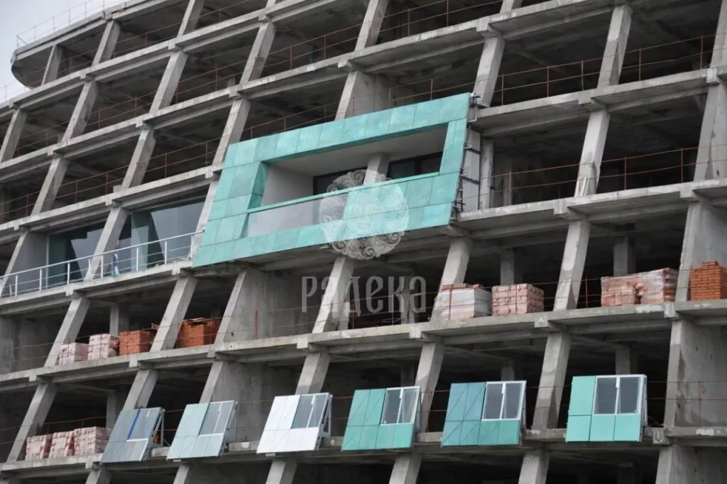 Section of copper cladding on the concrete frame of Reef Residence at an early stage of facade work.